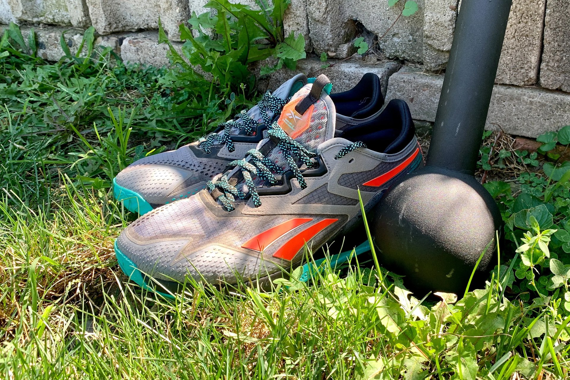 reebok nano x2 adventure shoes in grass next to a weight