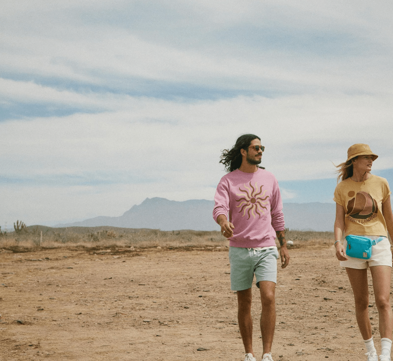 two people walking in desert