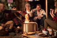 group of friends sitting around a solo stove fire pit
