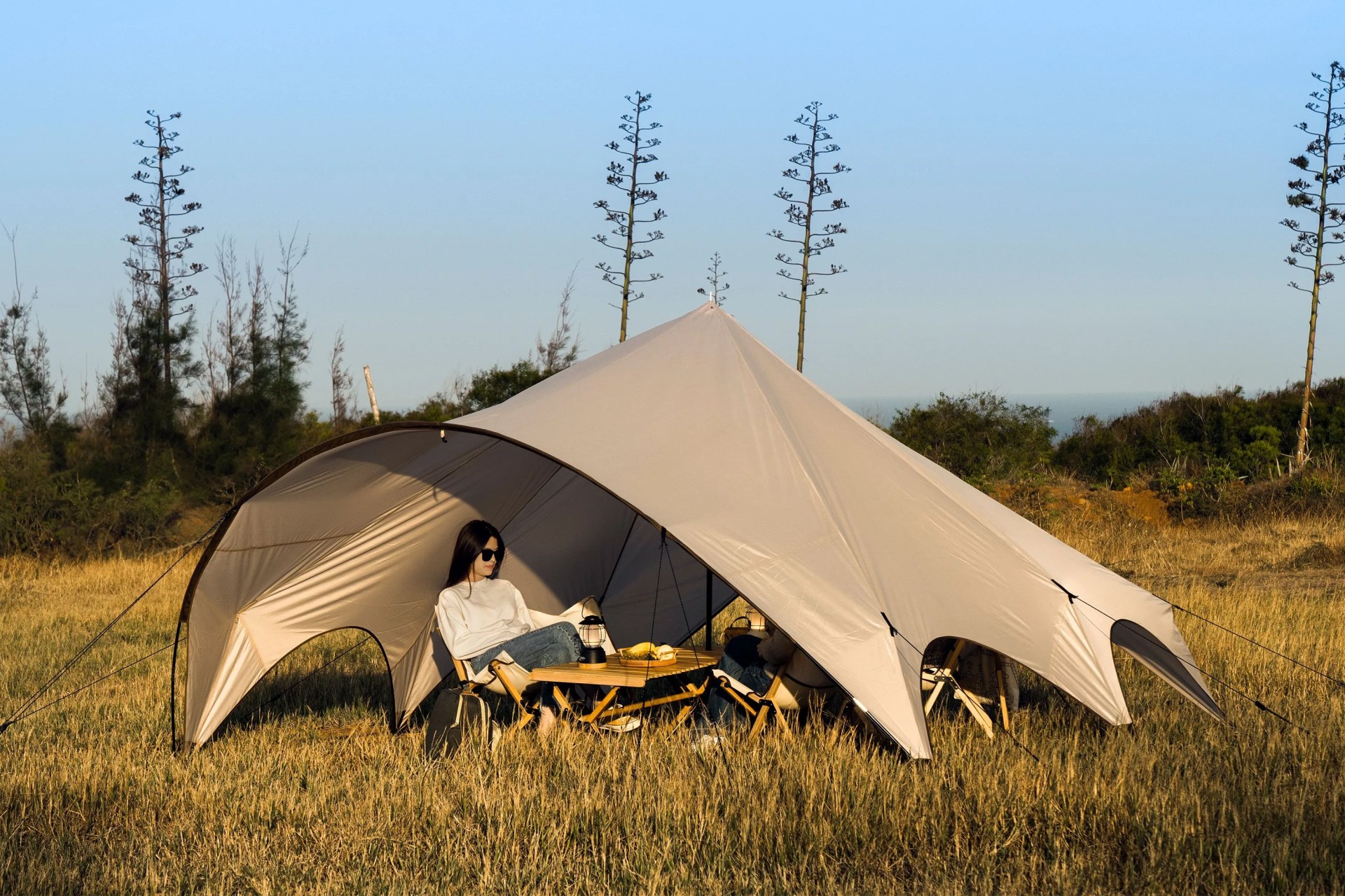 woman sitting under tarp shelter