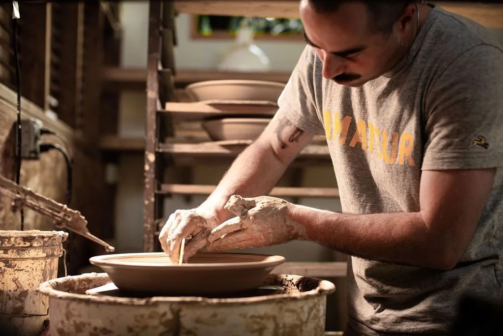 man working on a pottery wheel