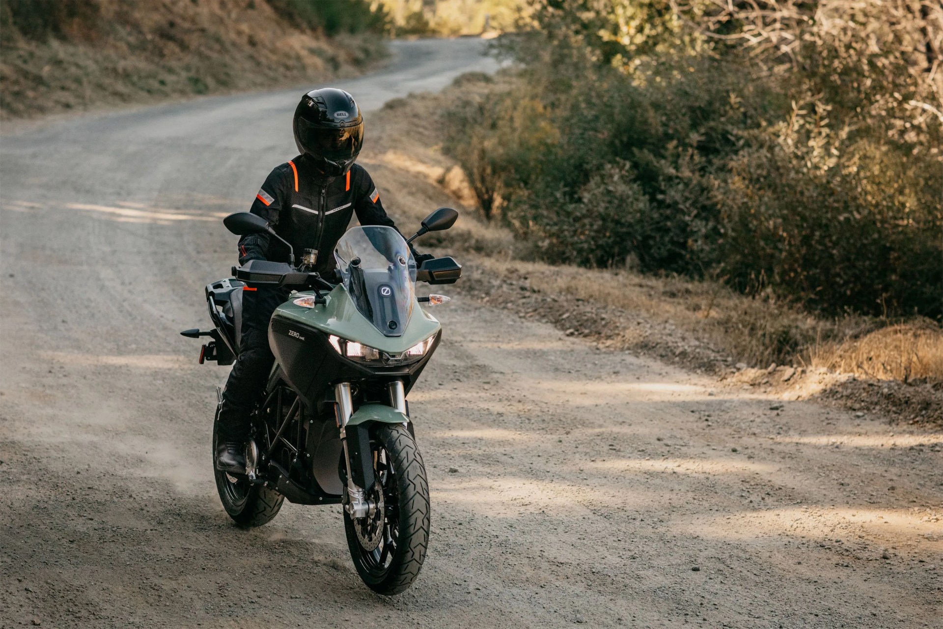 person riding a zero dsrx motorcycle on a dirt road