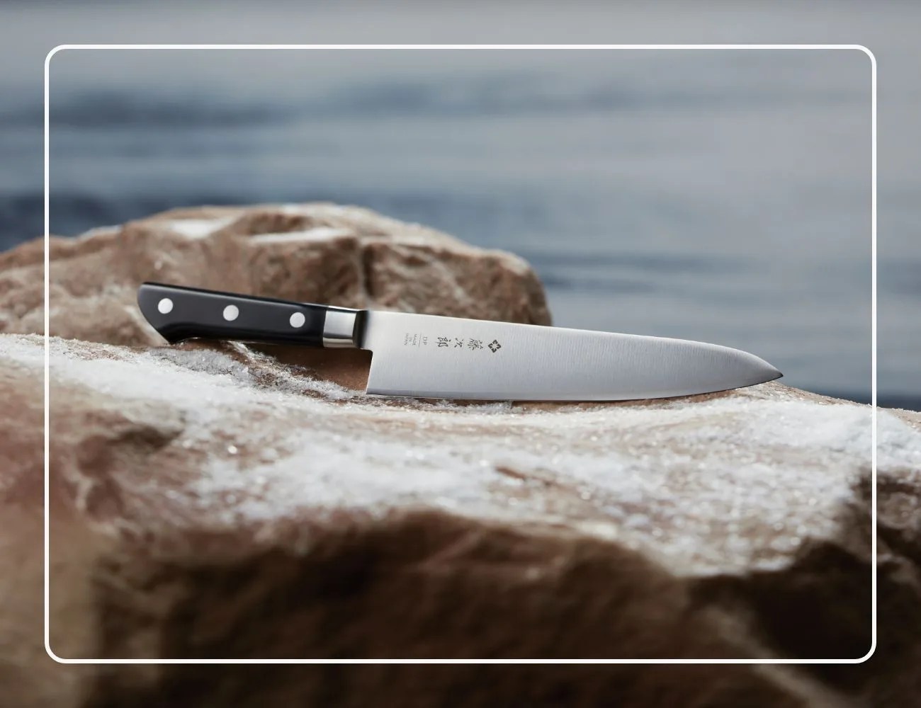 Tojiro DP Gyutou knife on rocks
