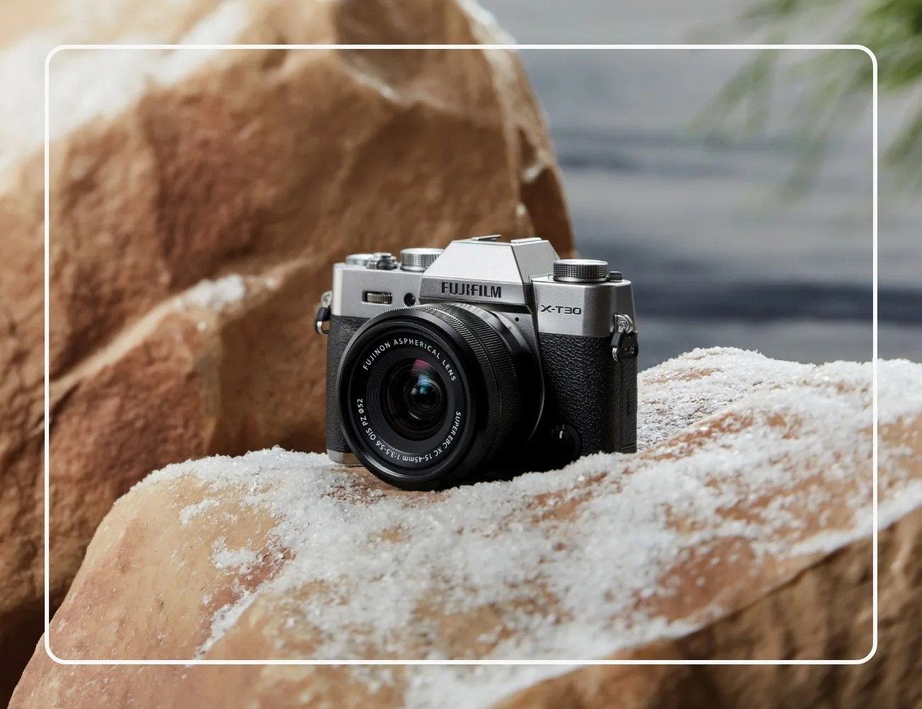 Fujifilm X-T30 II camera sitting on snowy rocks