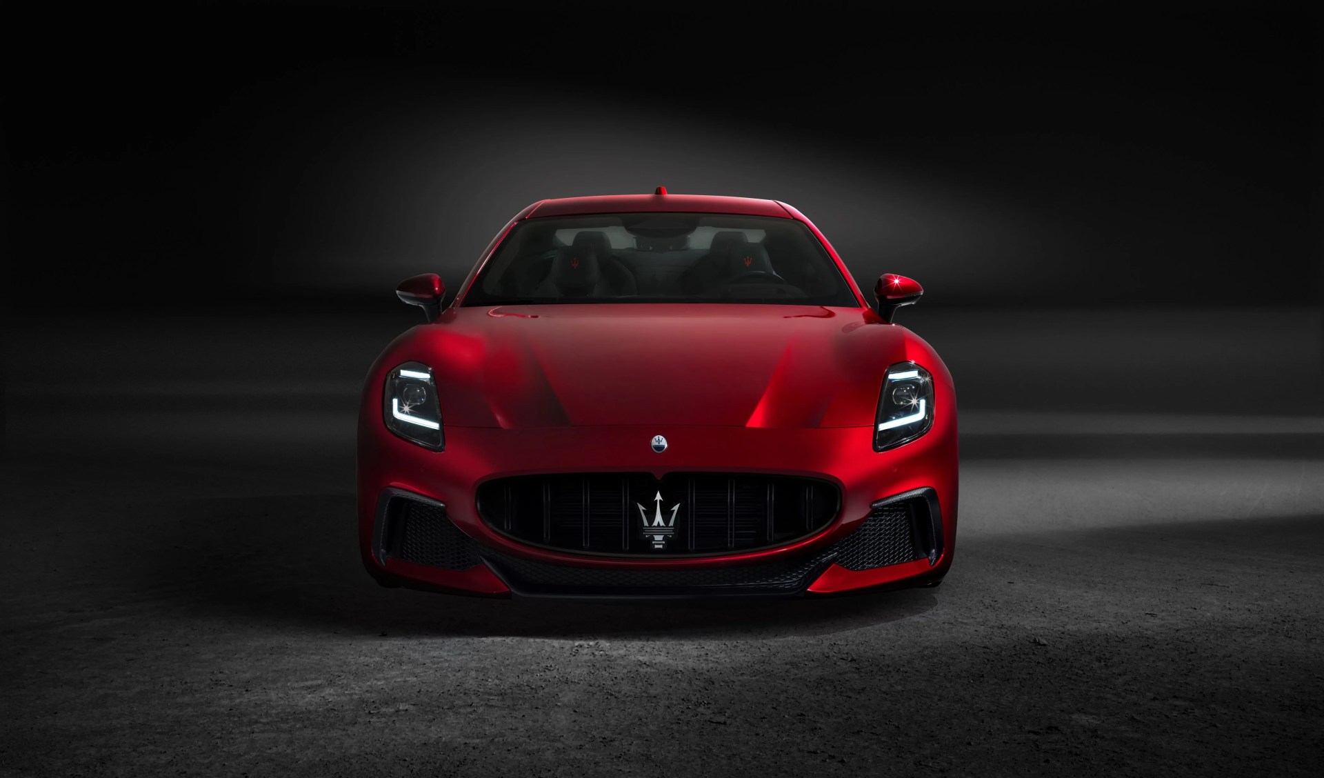 maserati gran truismo with a black studio background