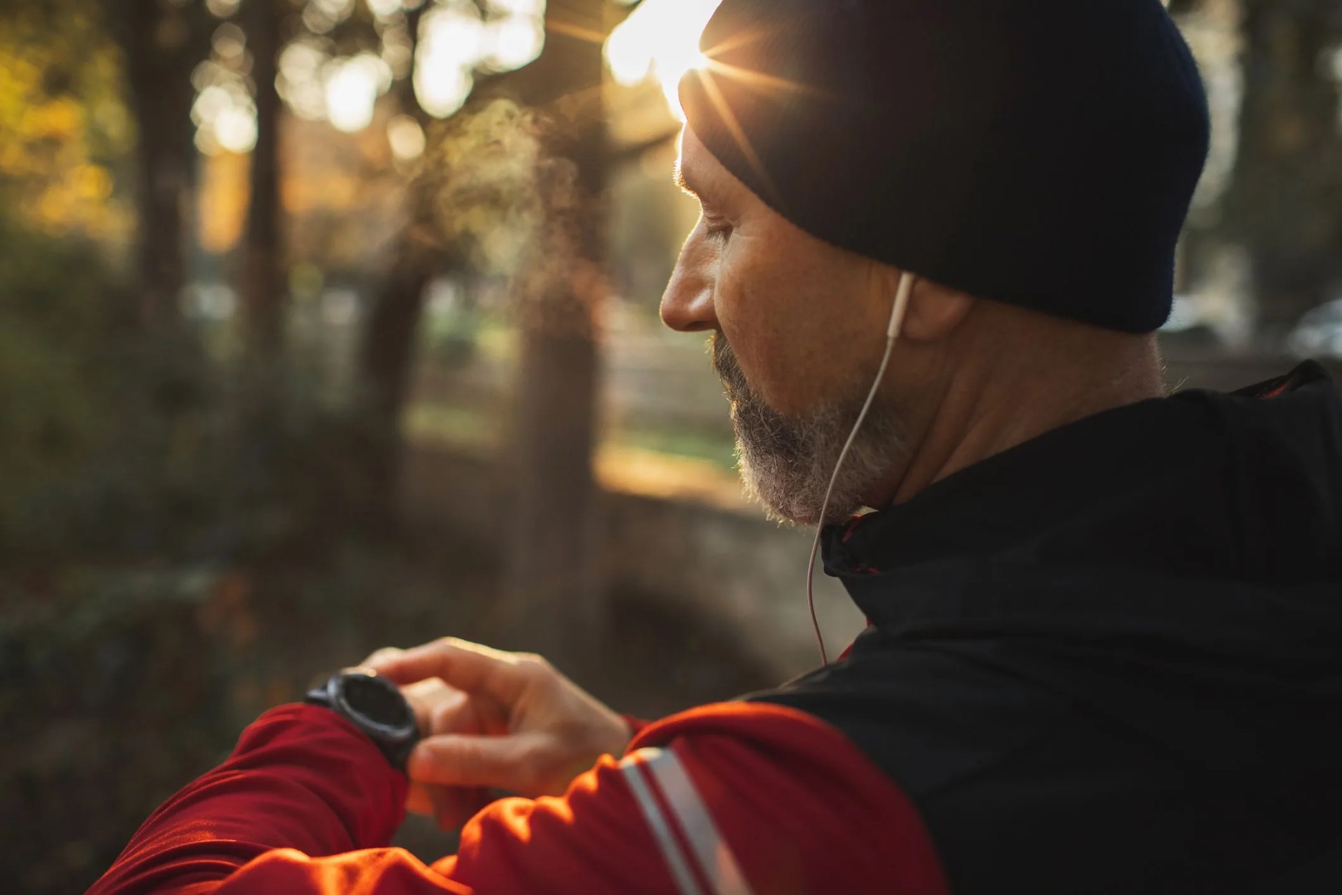 athletic runner start training on fitness tracker or smart watch and looking forward