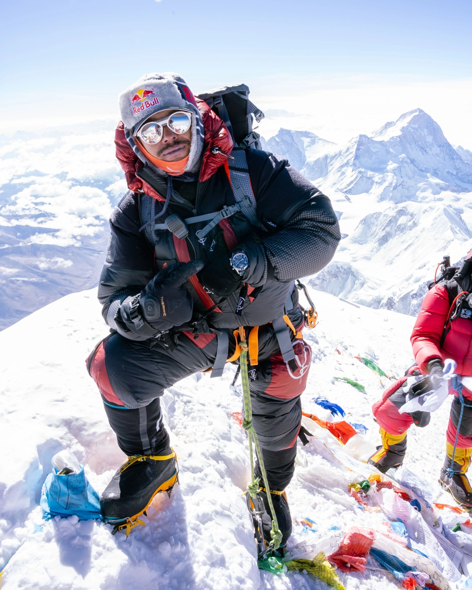 nimsdai purja climbing a snowy mountain showing off a montblanc watch