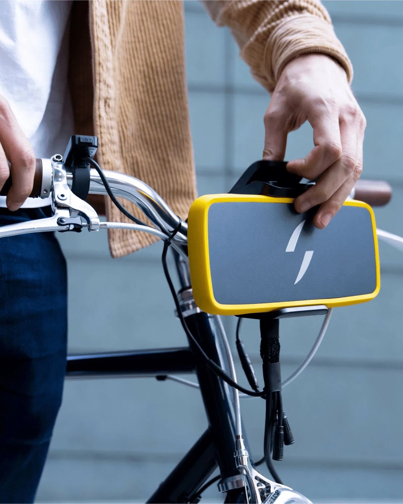 man installing swytch the simple electric bike kit