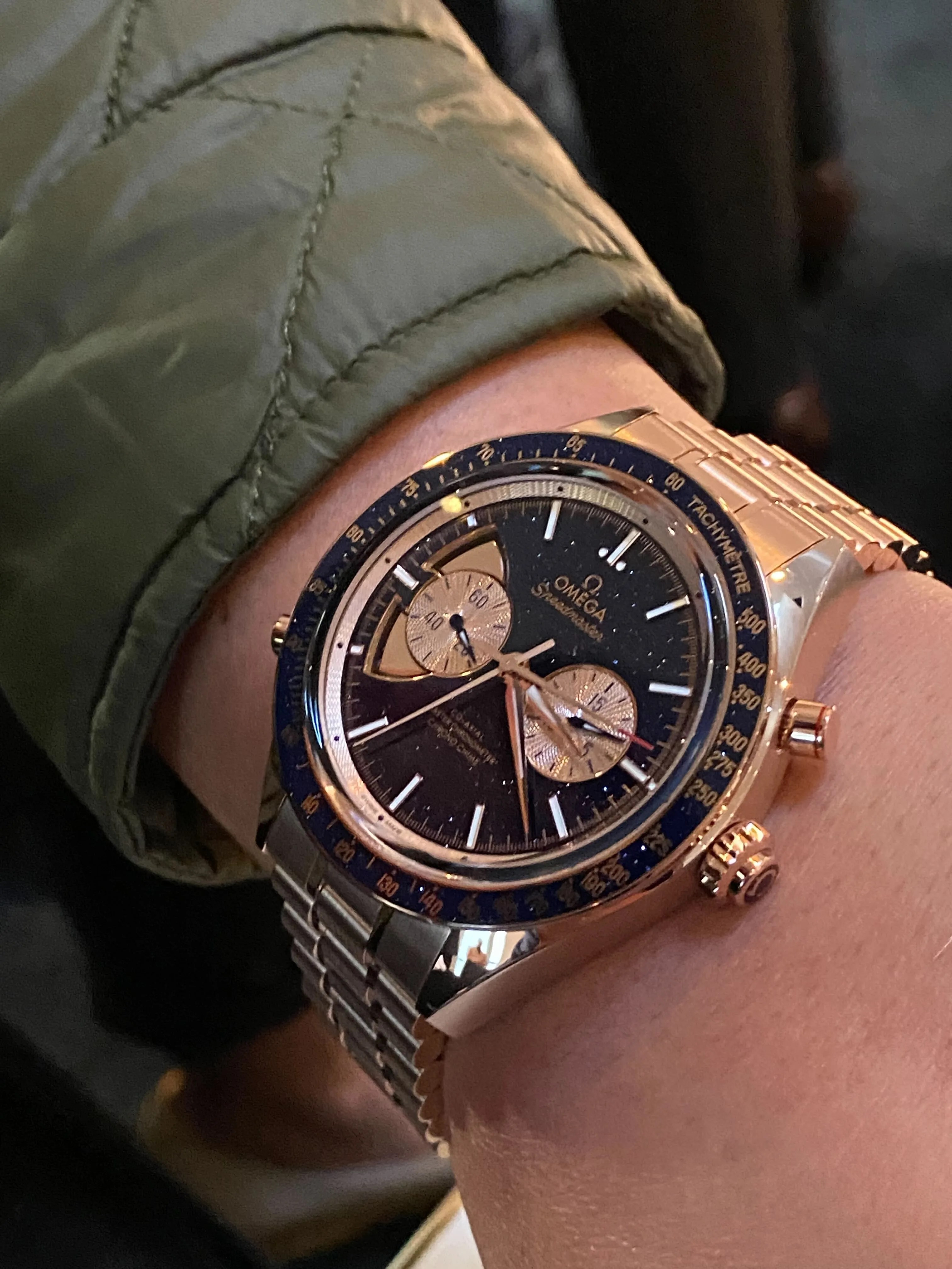 gold omega speedmaster on wrist