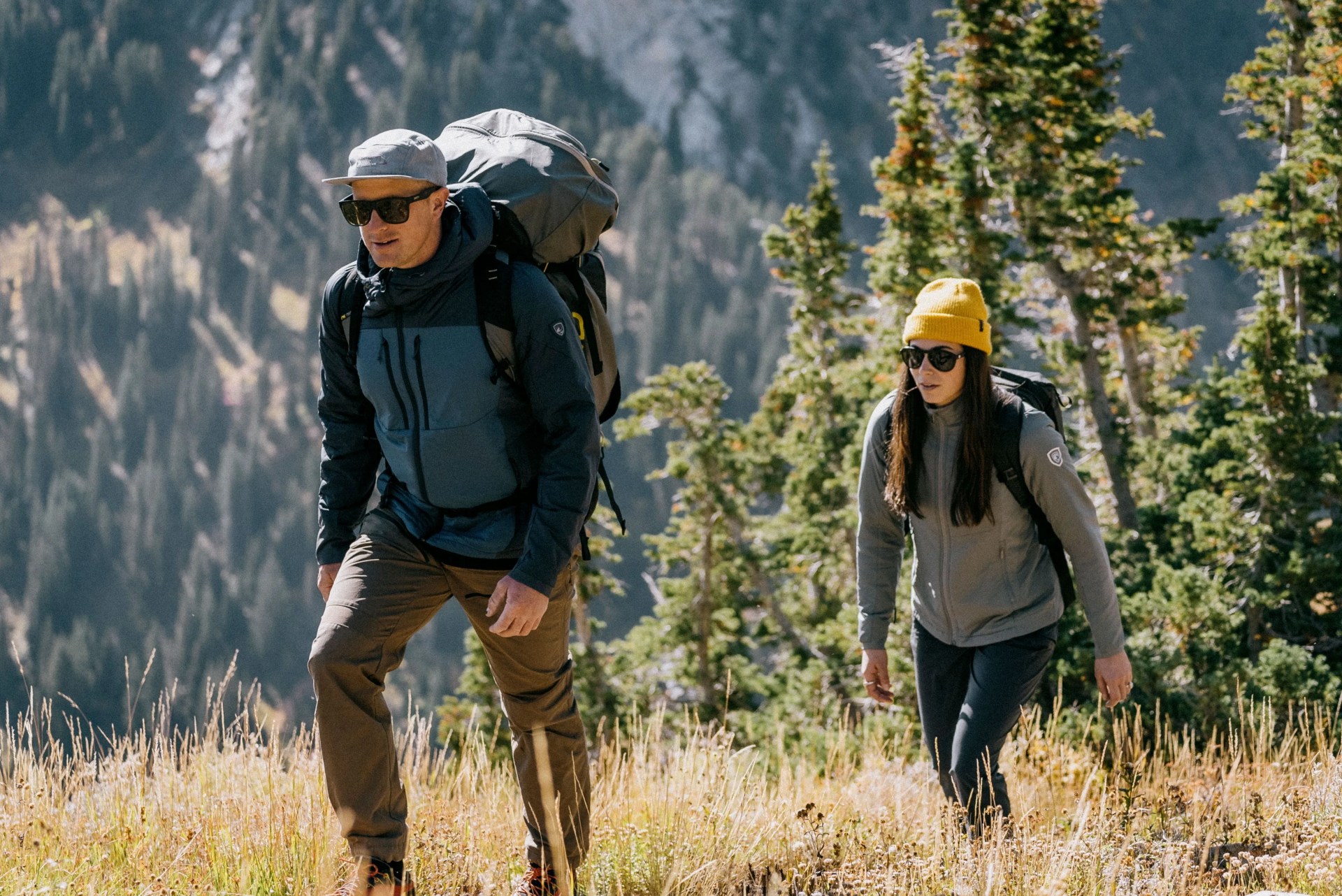 man wearing kühl activator jacket while hiking with a woman