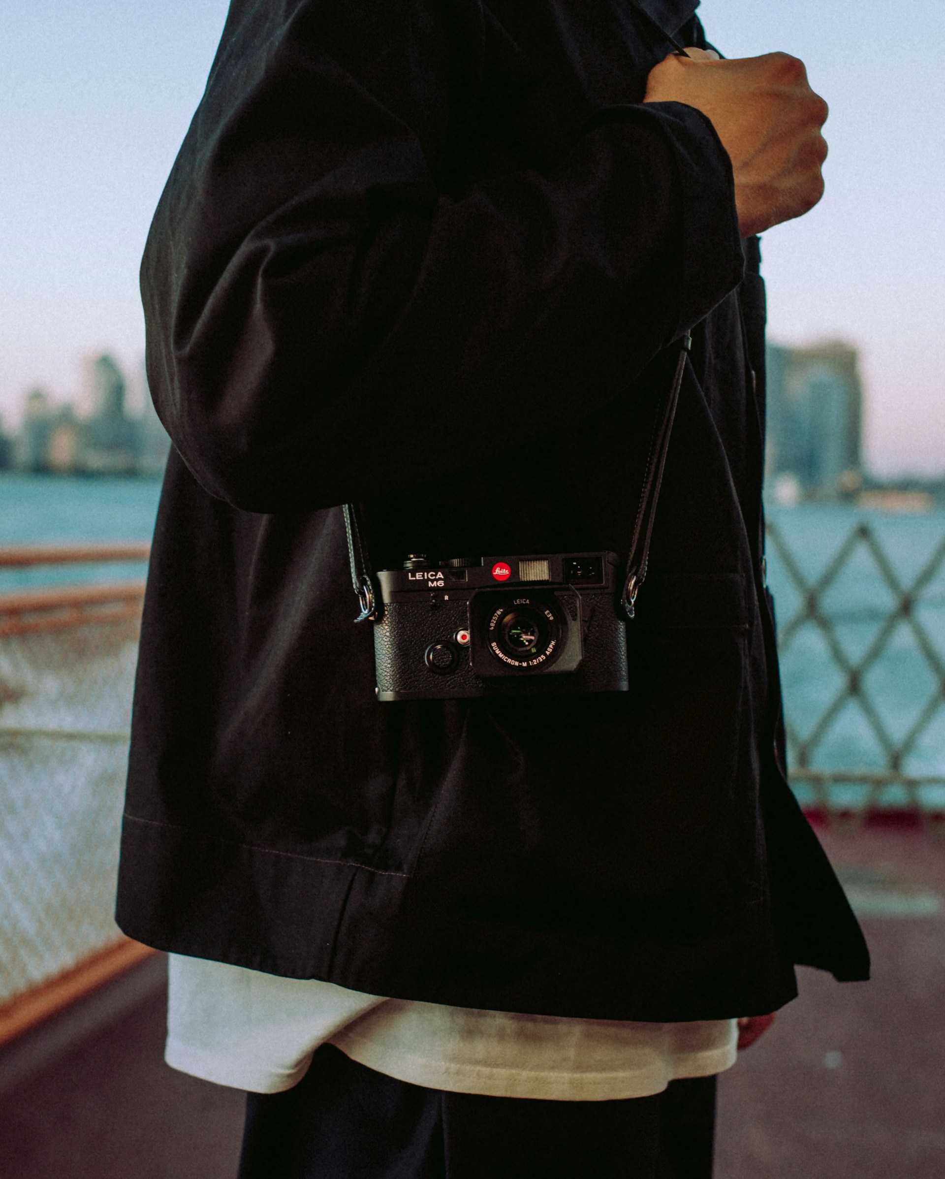 man carrying leica m6 camera