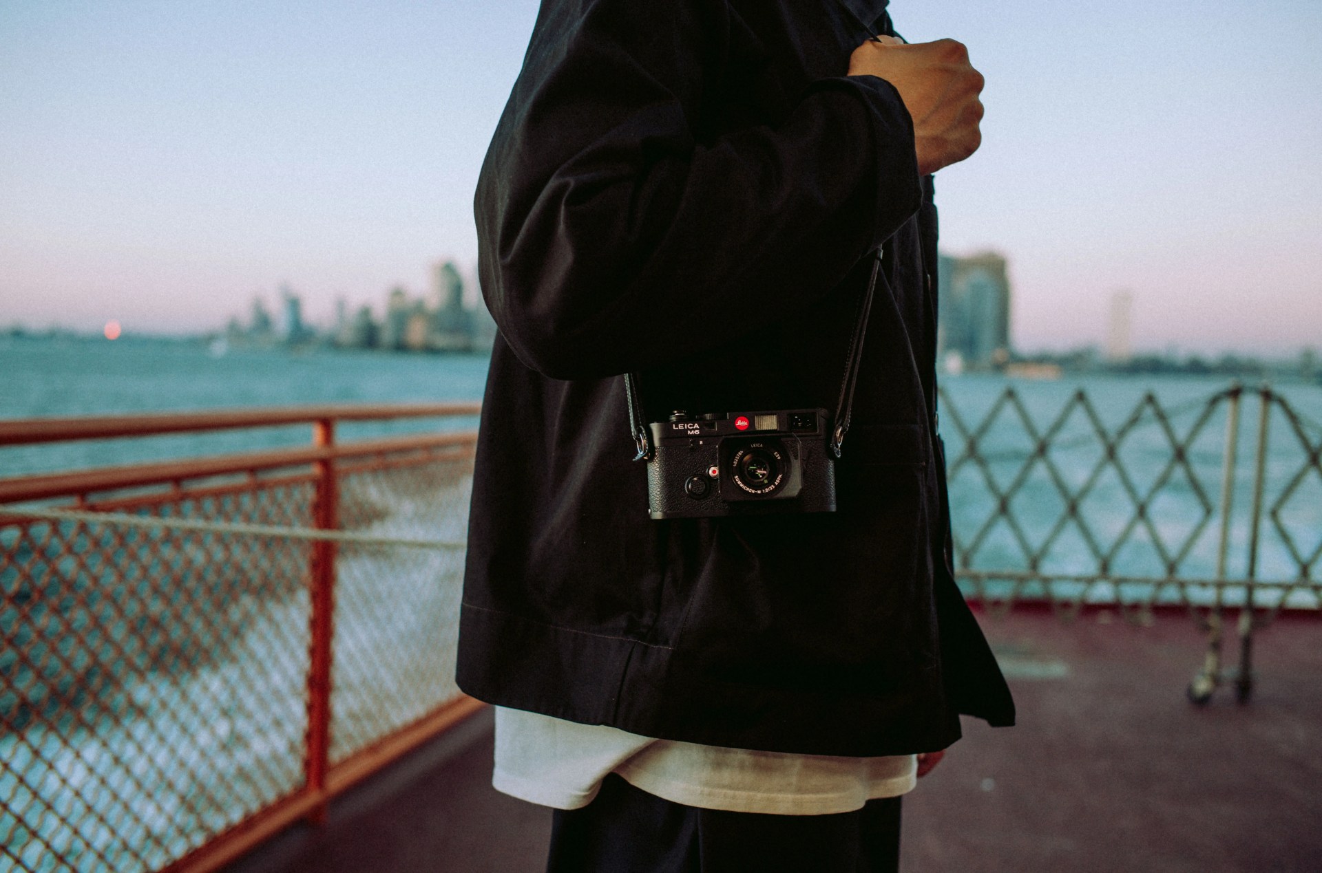 man carrying leica m6 camera