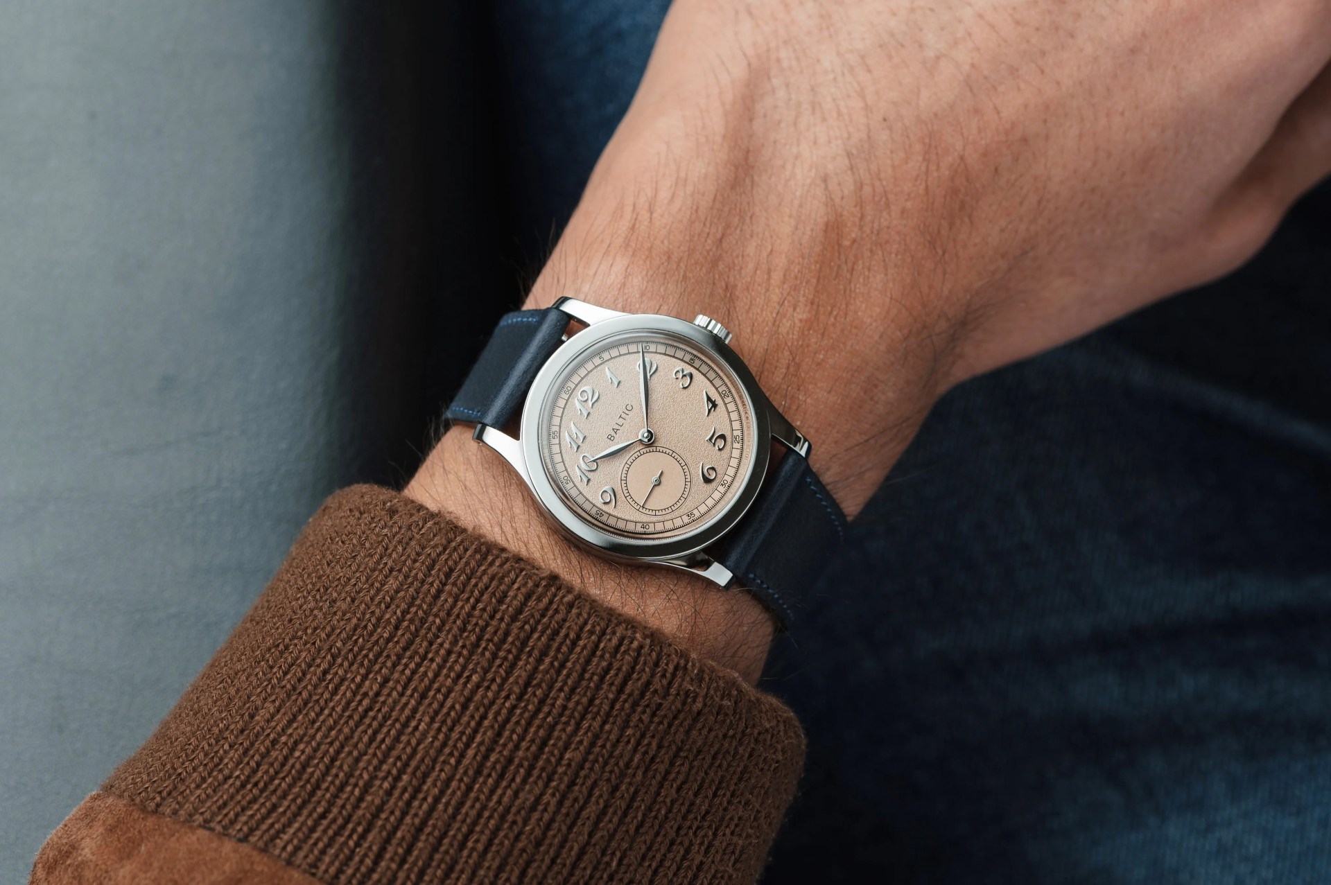 person wearing a baltic watch on their wrist