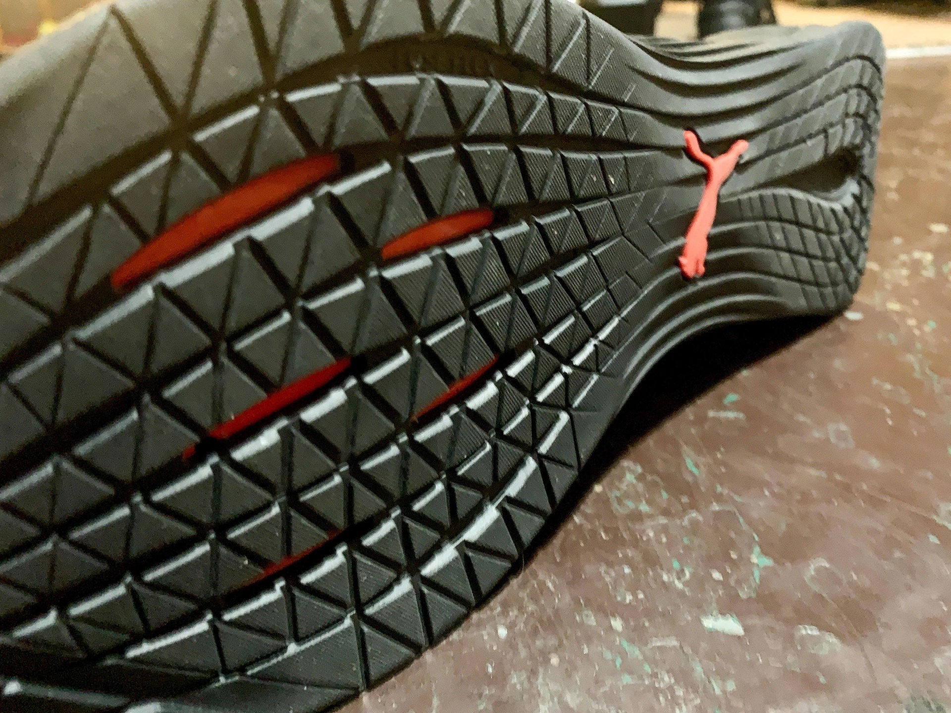 close up of the bottom traction on a red puma fuse shoe