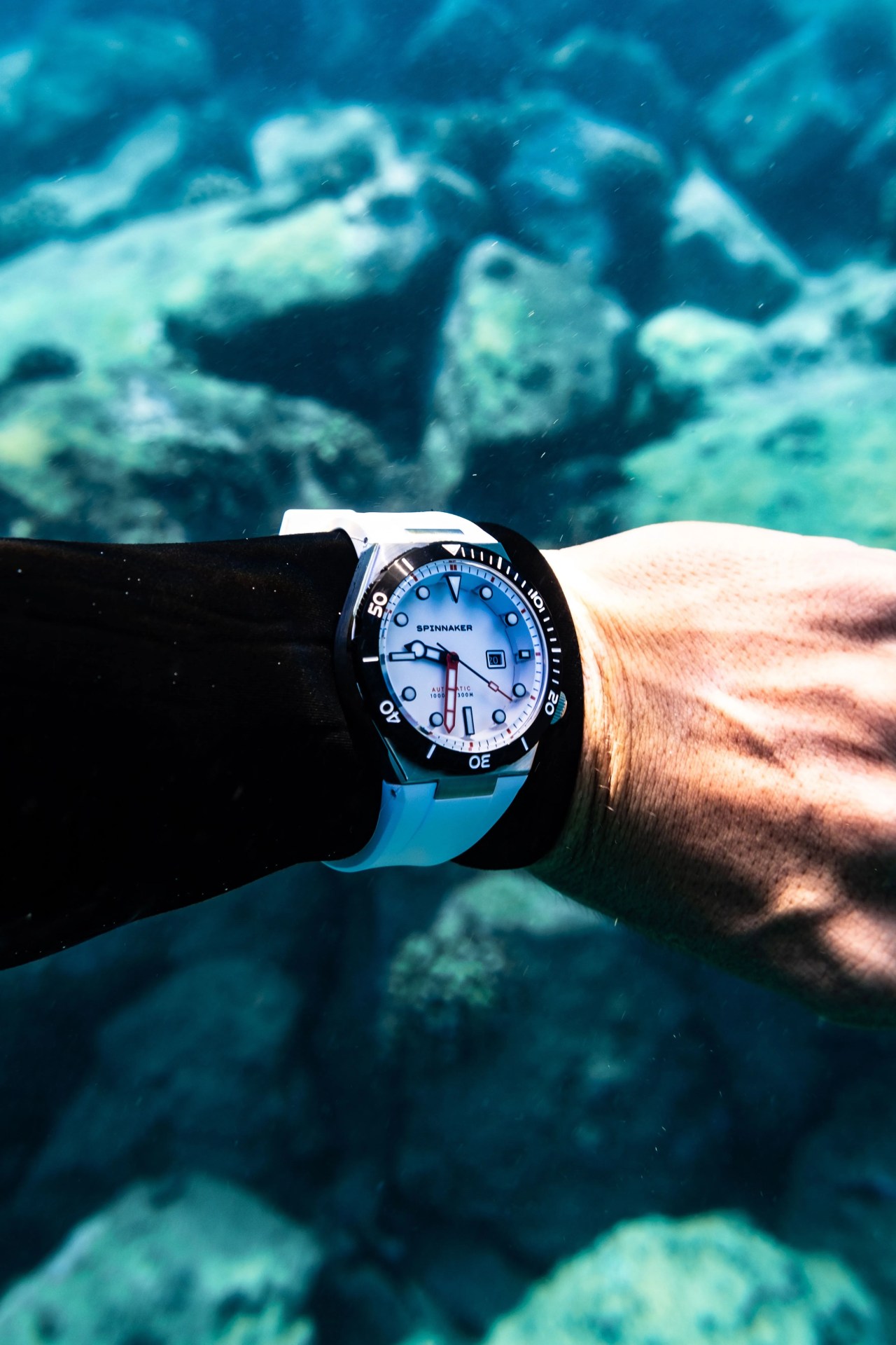 man wearing spinnaker boettger automatic watch underwater