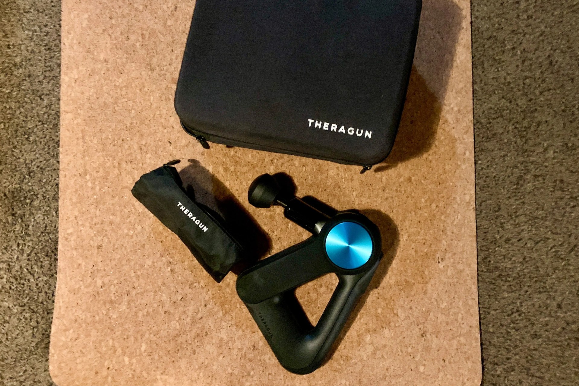 therabody theragun pro massag gun on a yoga mat