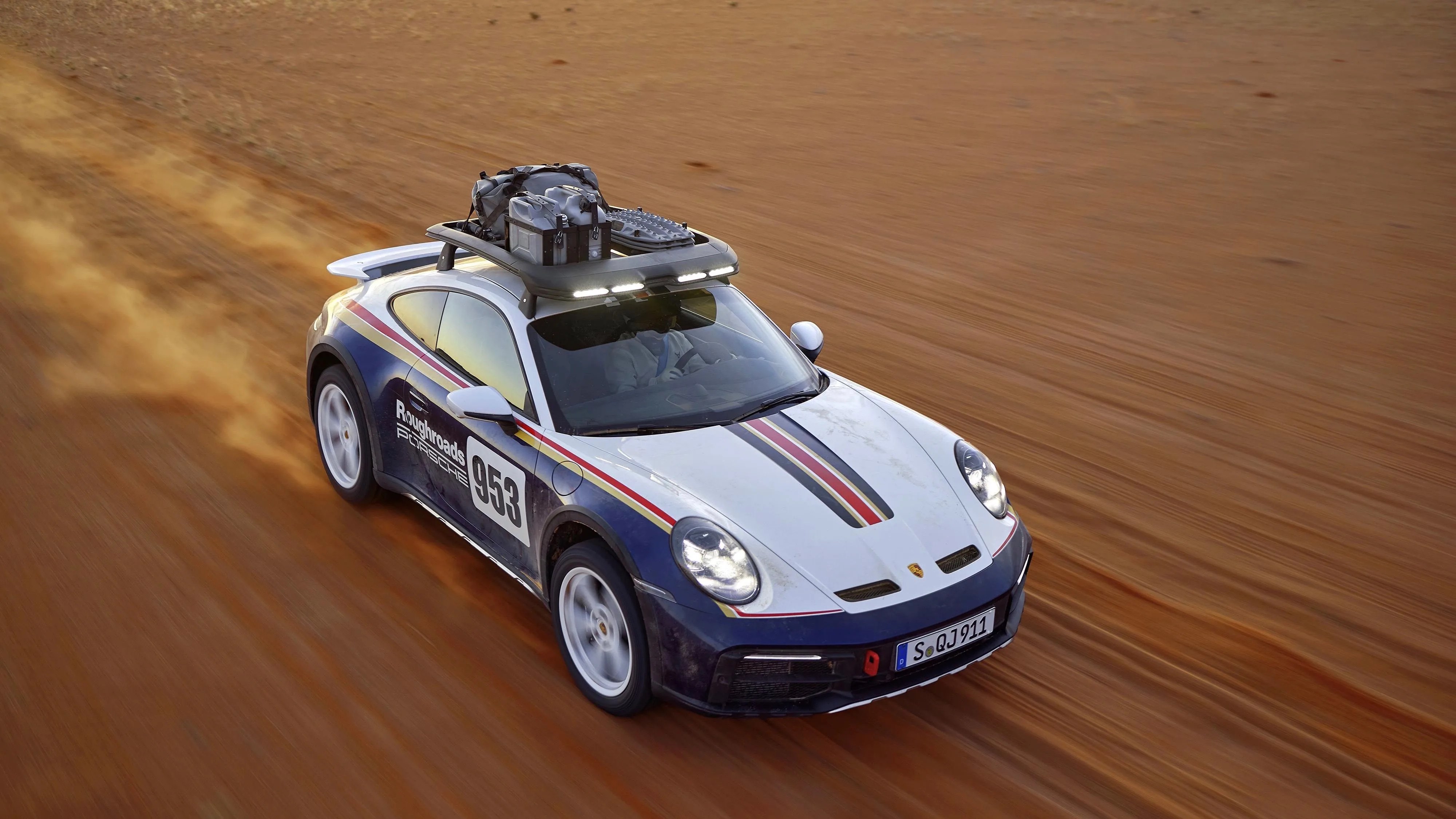 porsche 911 dakar driving on sand