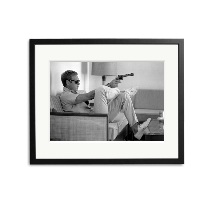 Steve McQueen aims a pistol