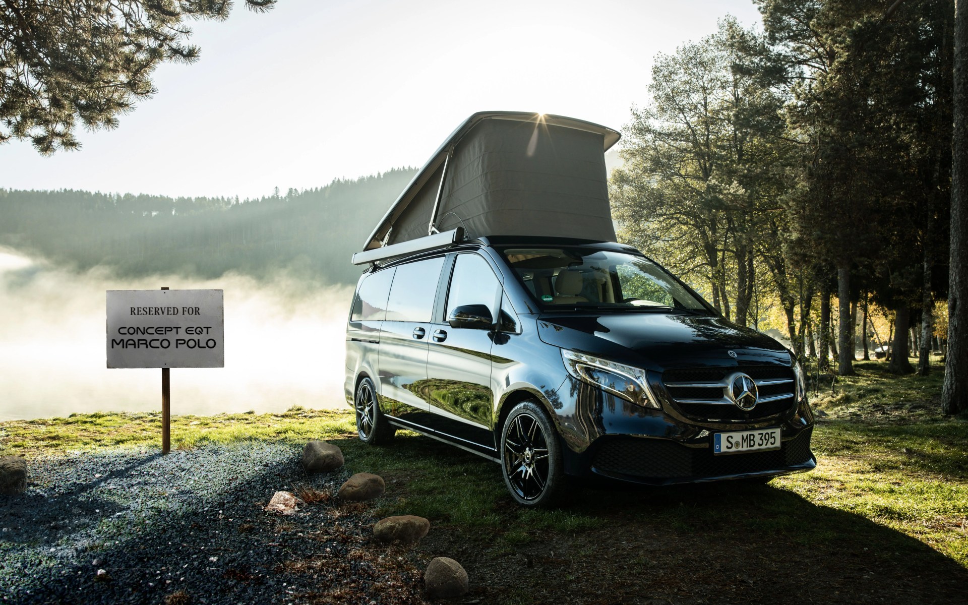 mercedes camper van with pop top roof next to a sign teasing the eqt marco polo concept