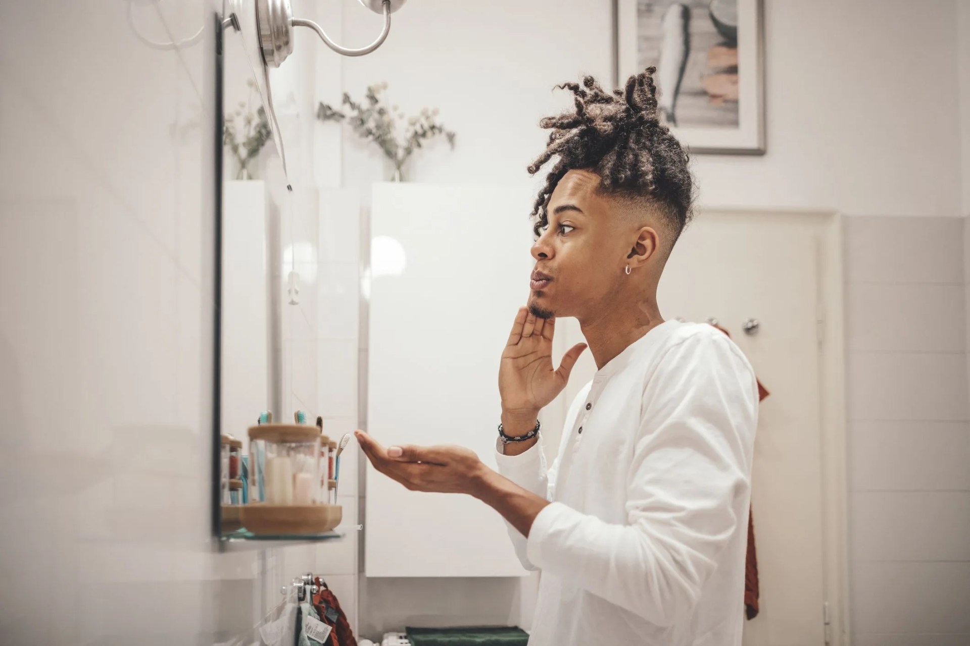 at home young man brushing his teeth