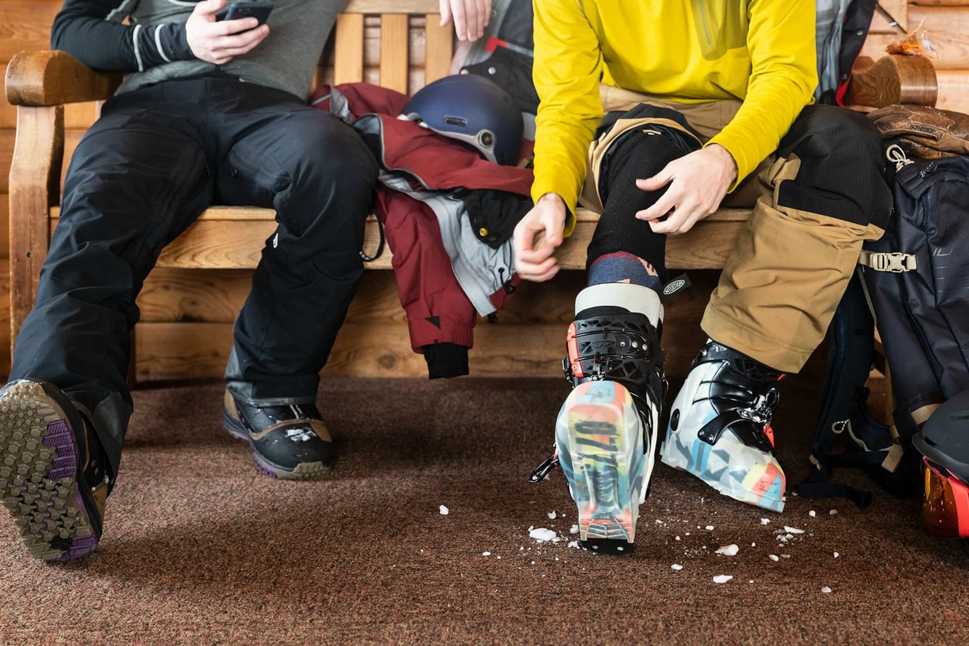 2 people getting ready to go hit a ski hill