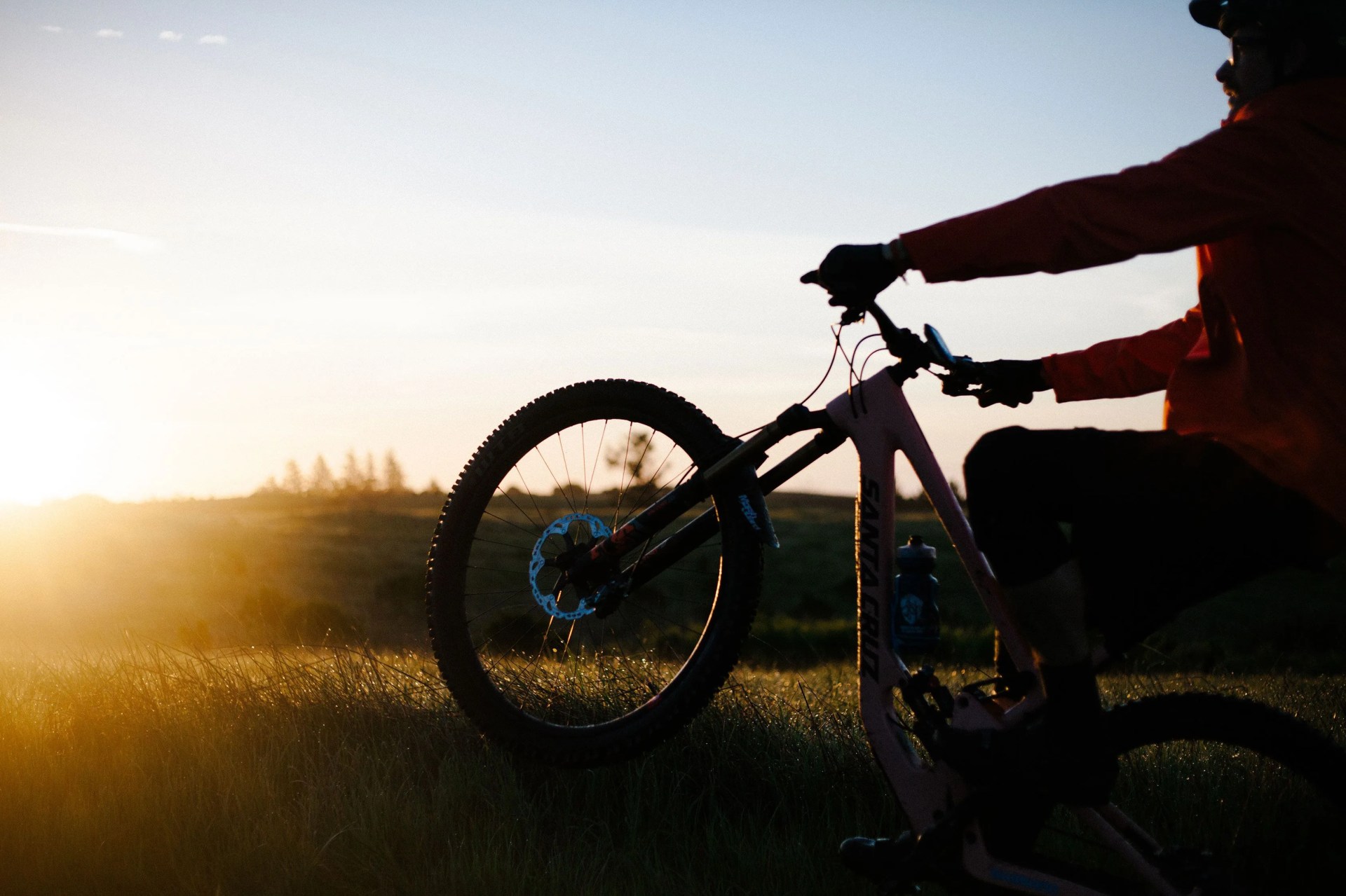 man riding a bicycle popping a wheelie