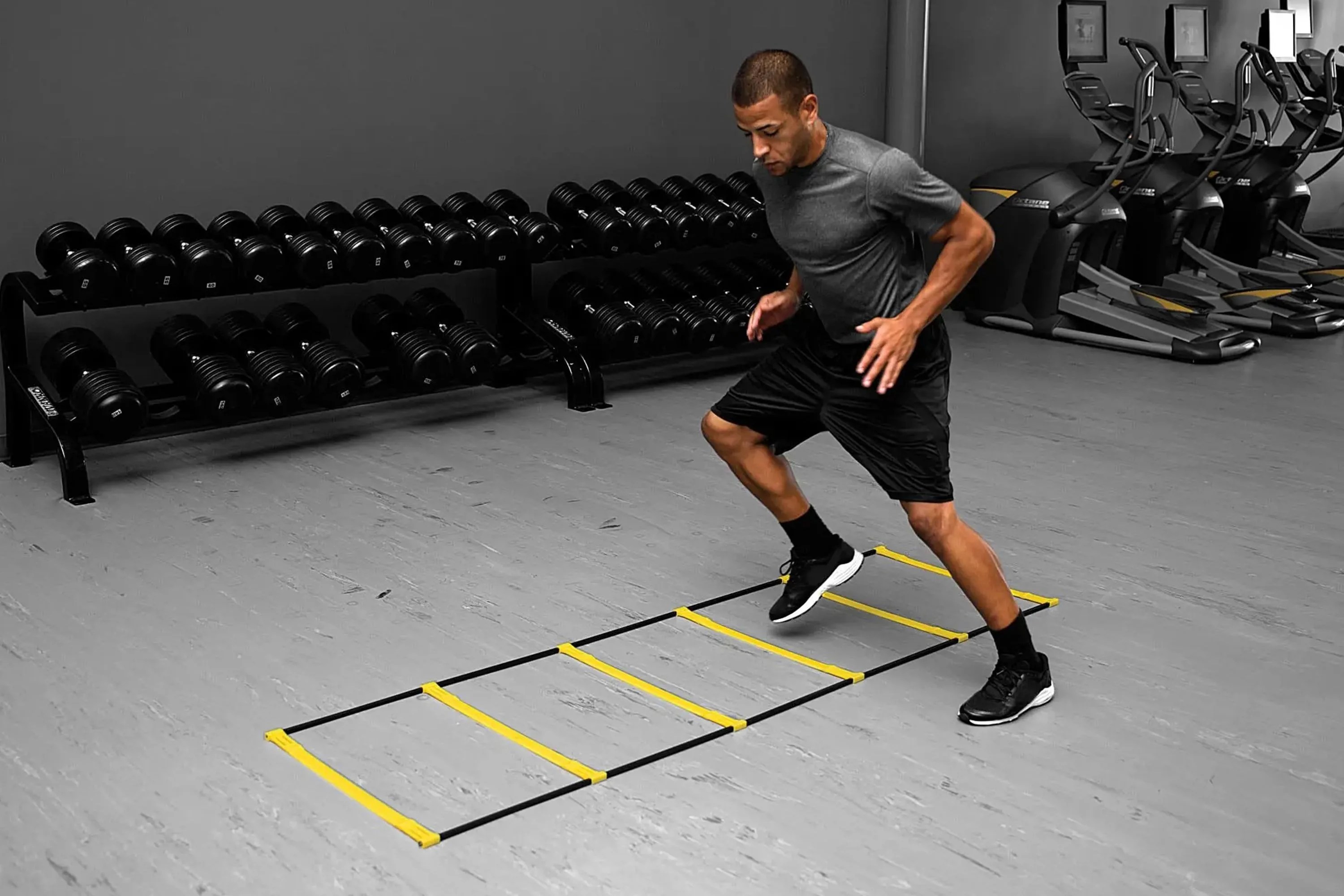 a man working out in a gym with an agility ladder