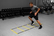 a man working out in a gym with an agility ladder