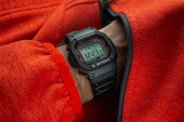 man wearing a casio watch and red zip up sweatshirt