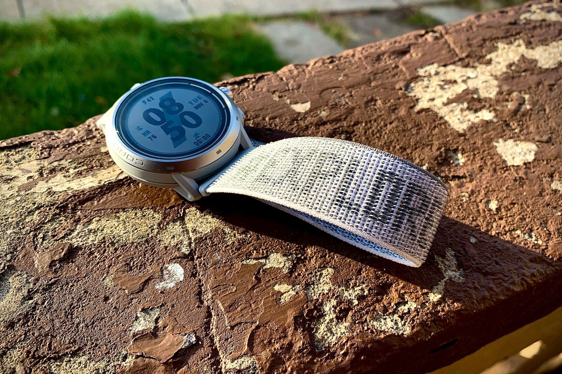 a coros watch sitting on a porch ledge