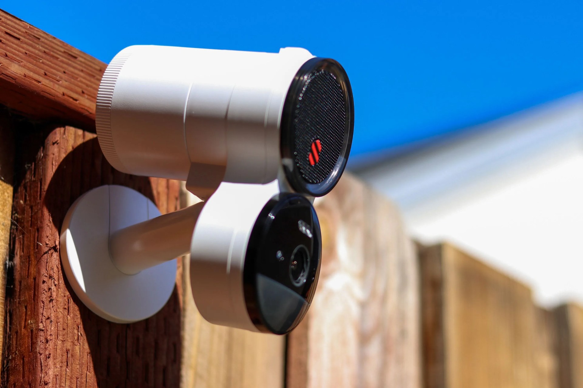 deep sentinel security camera mounted on wooden fence