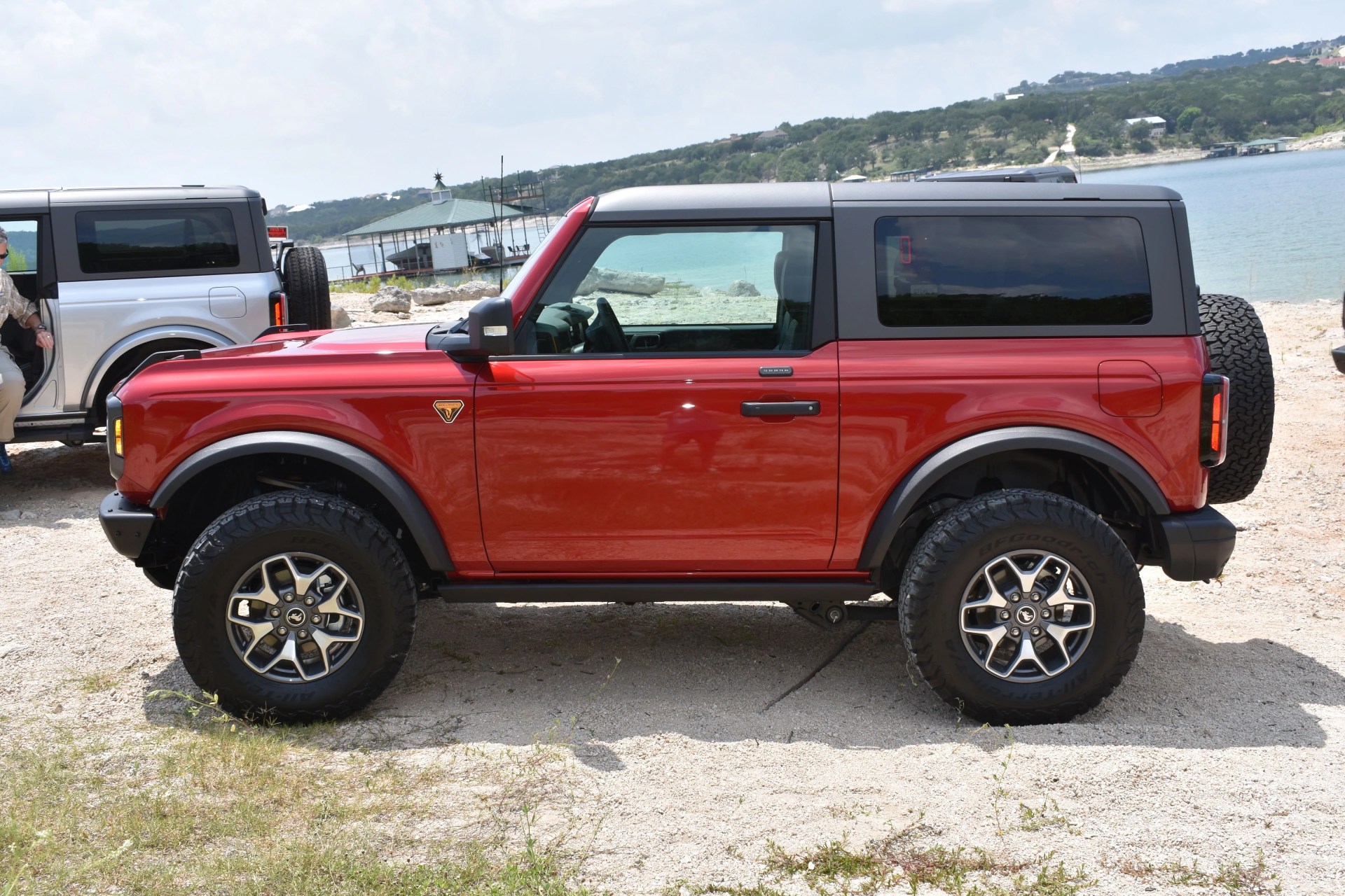 red ford bronco parked on a riverside beach in texas