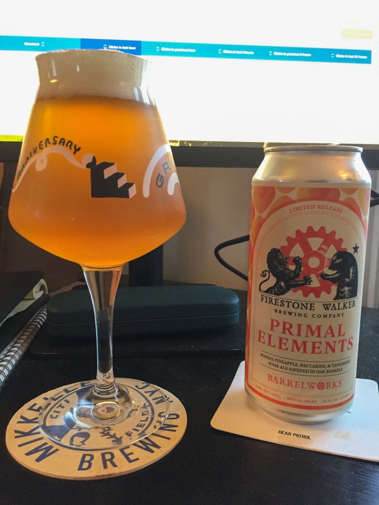 a can of firestone walker primal elements next to a glass of it on a table