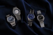 four watches on blue fabric