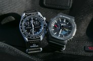 an omega watch and g shock watch next to each other on a black fabric background