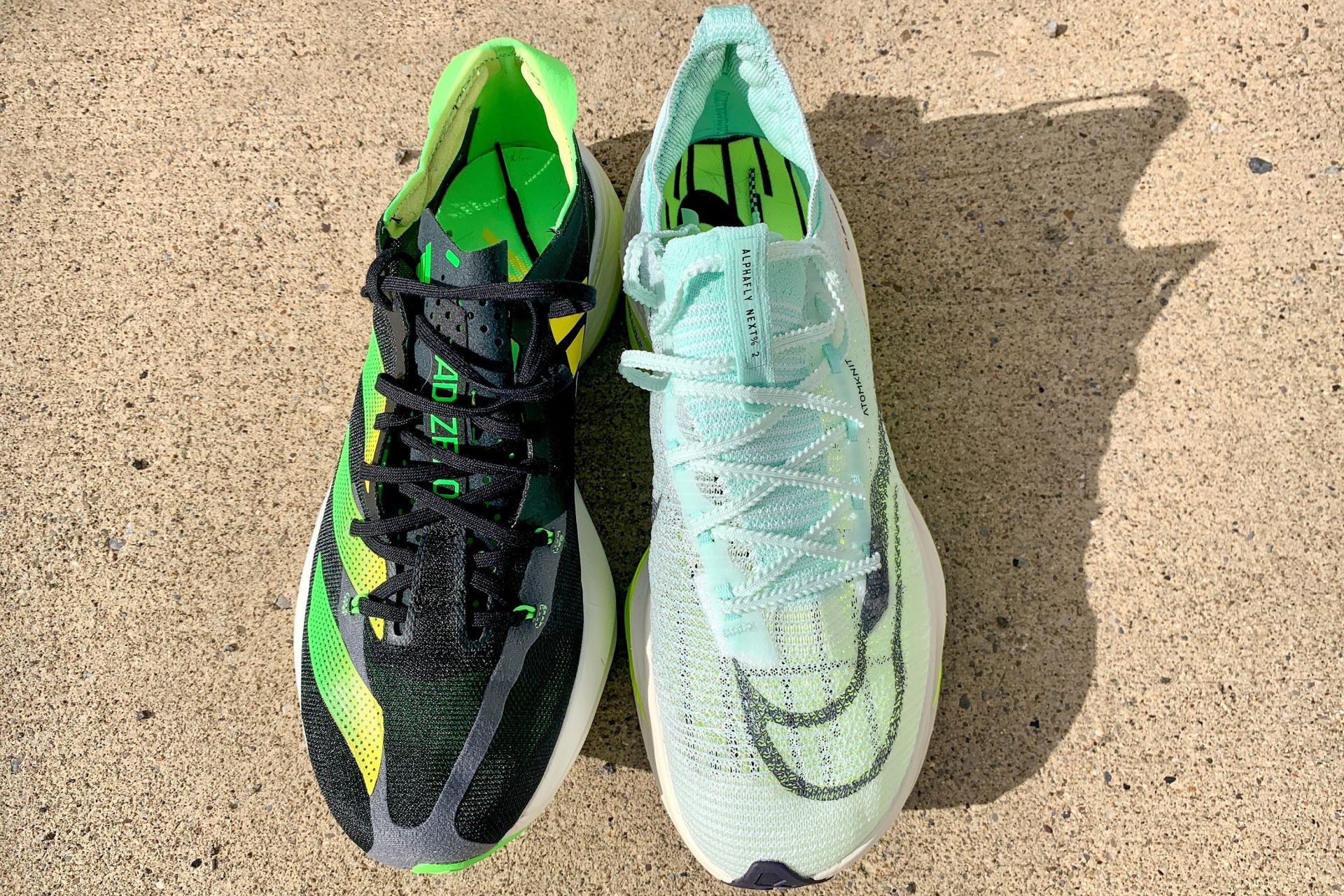 two sneakers next to each other on a sidewalk