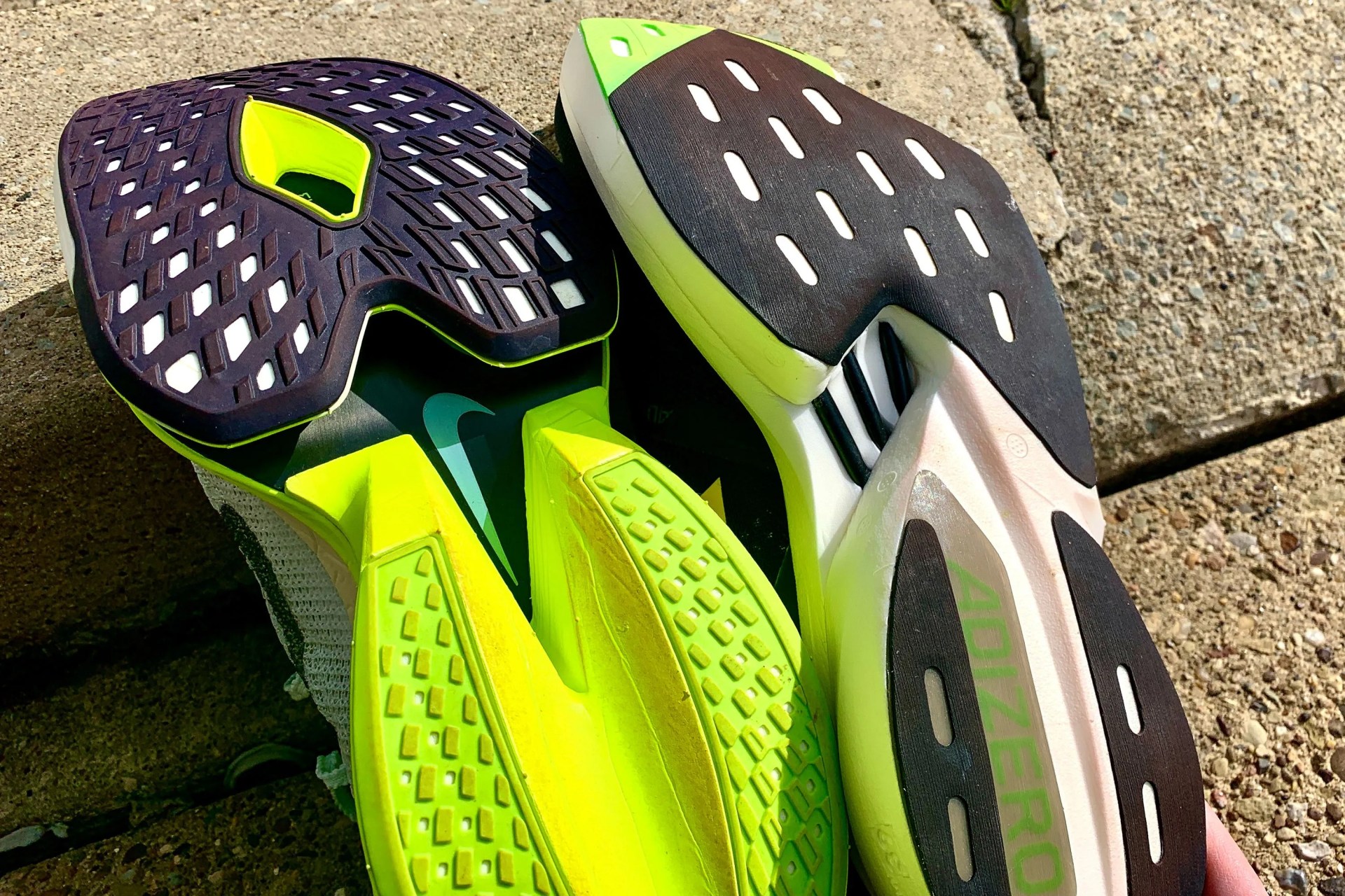 underside of adidas and nike running shoes