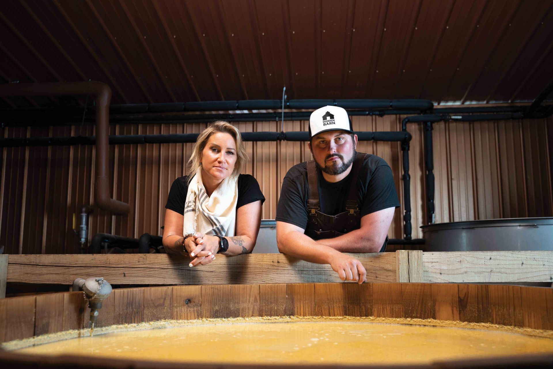 zykan and neeley at one of their cypress fermentation tanks