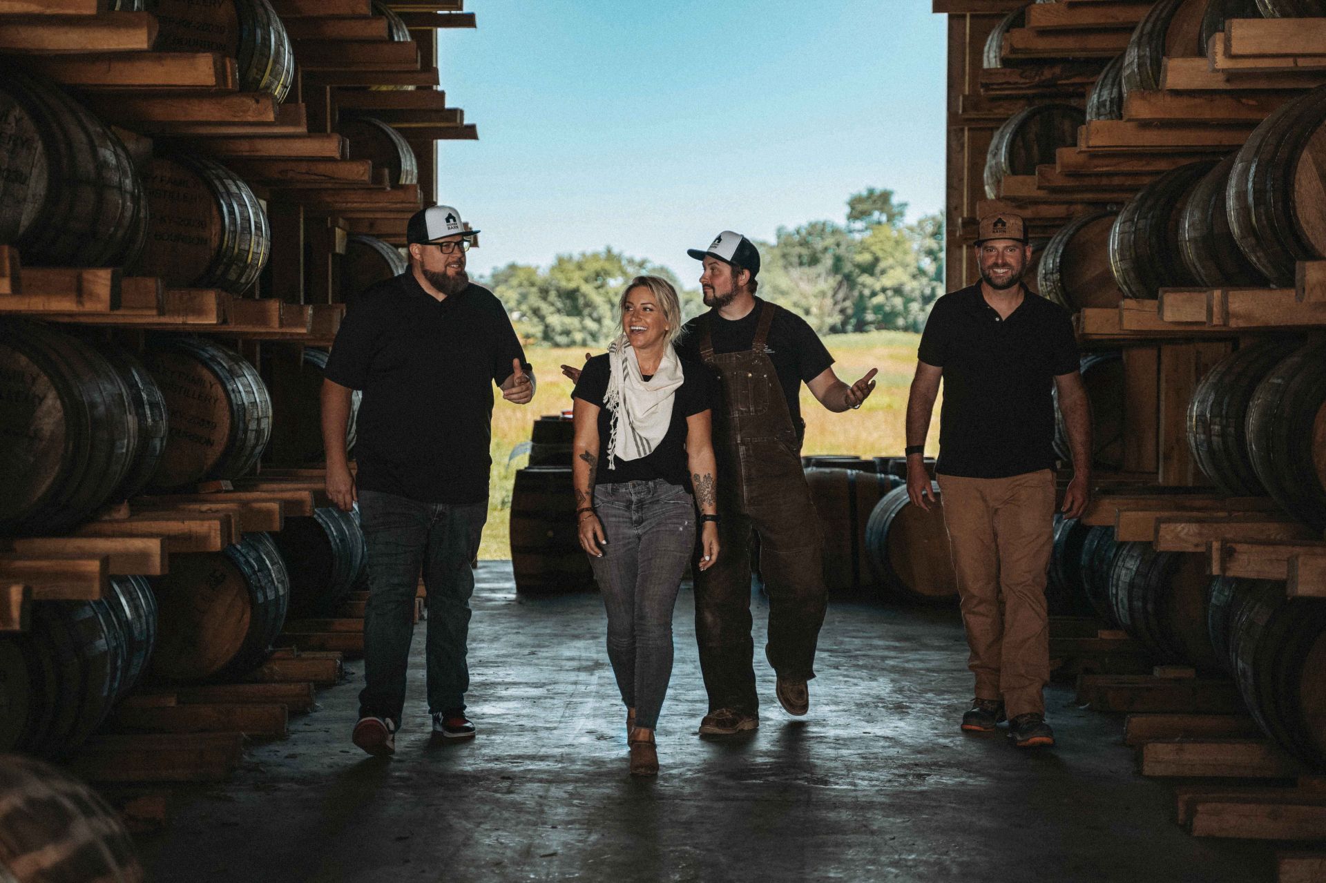 hidden barn whiskey distillers in front of barn
