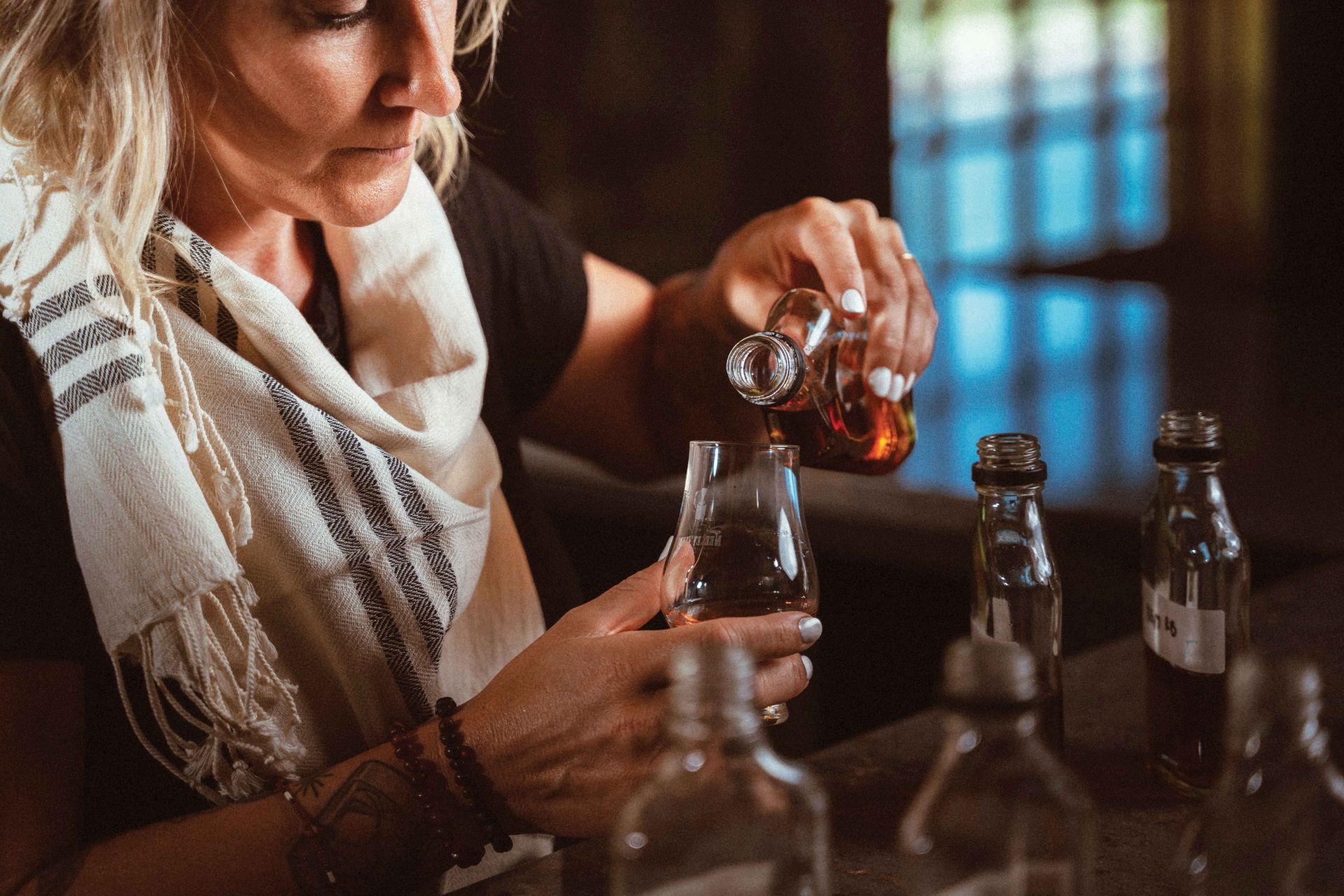 zykan pouring her whiskey into a glass for tasting