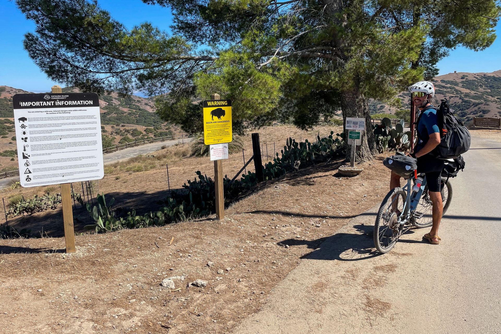 a man on a bike at the start of a trail