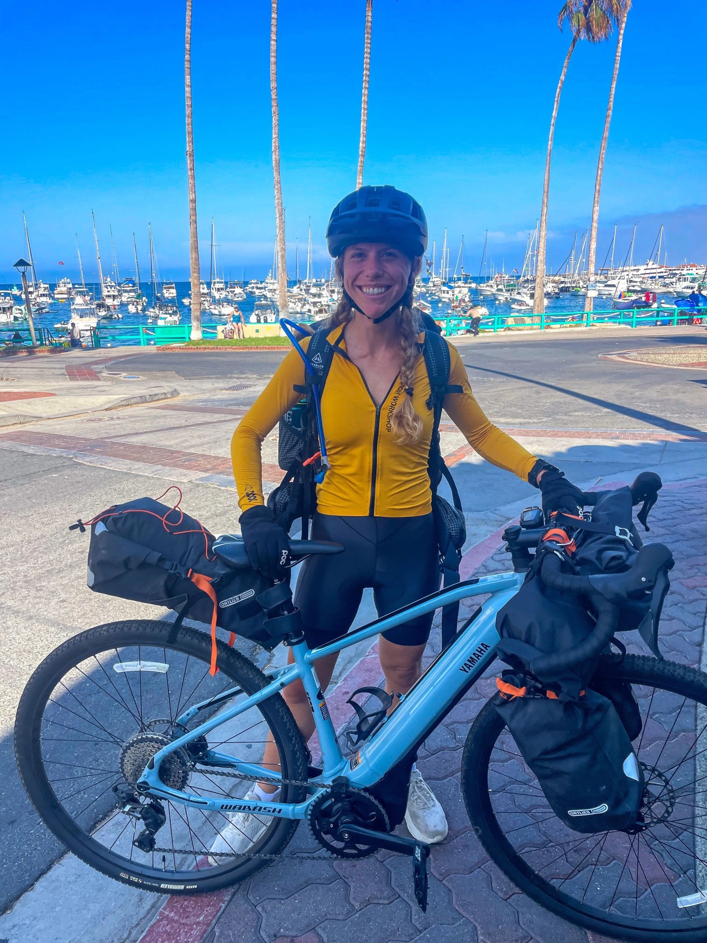 a woman standing next to a bike