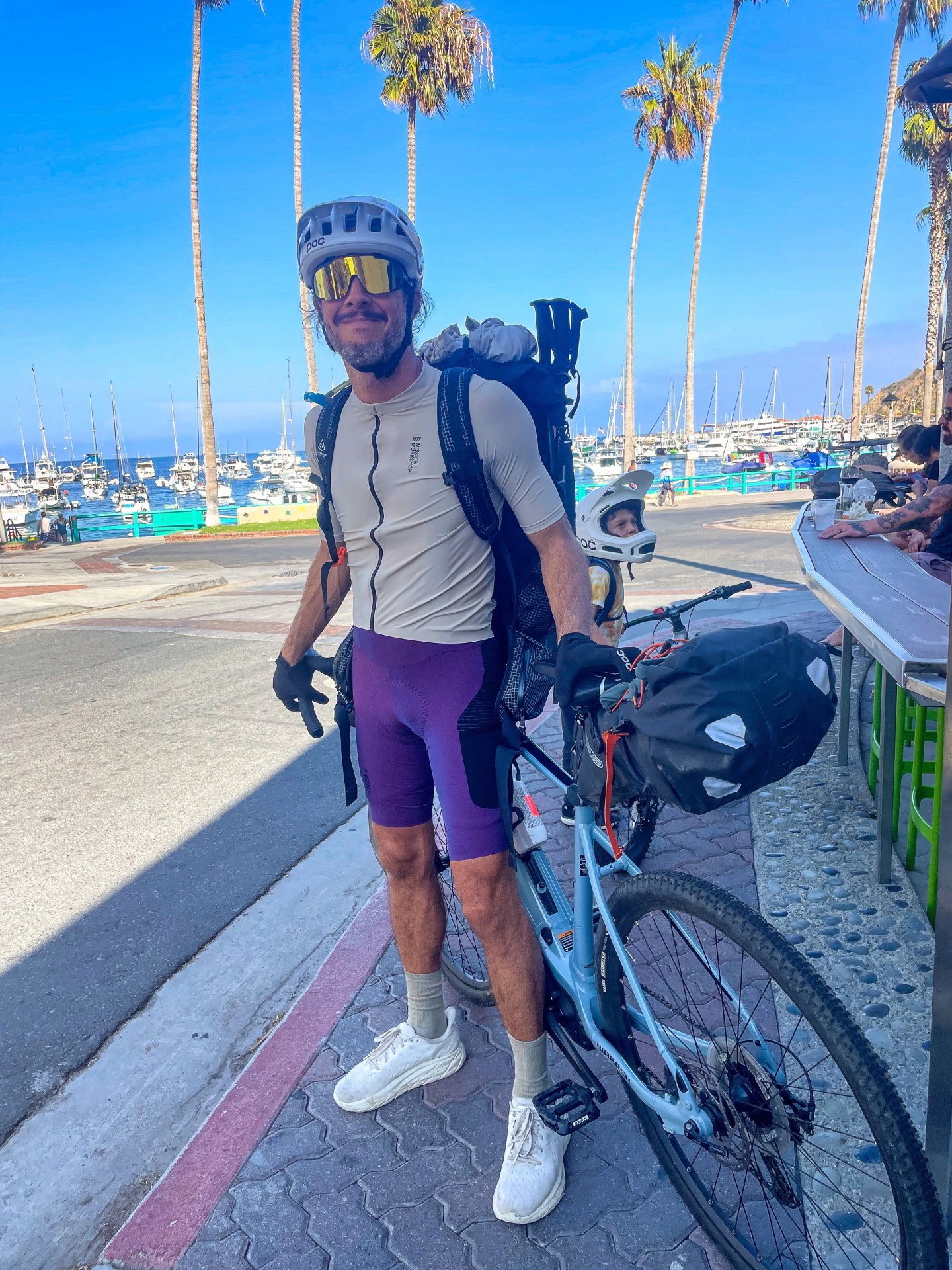 a man standing next to a bike