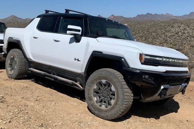 hummer ev sut parked on a dirt trail