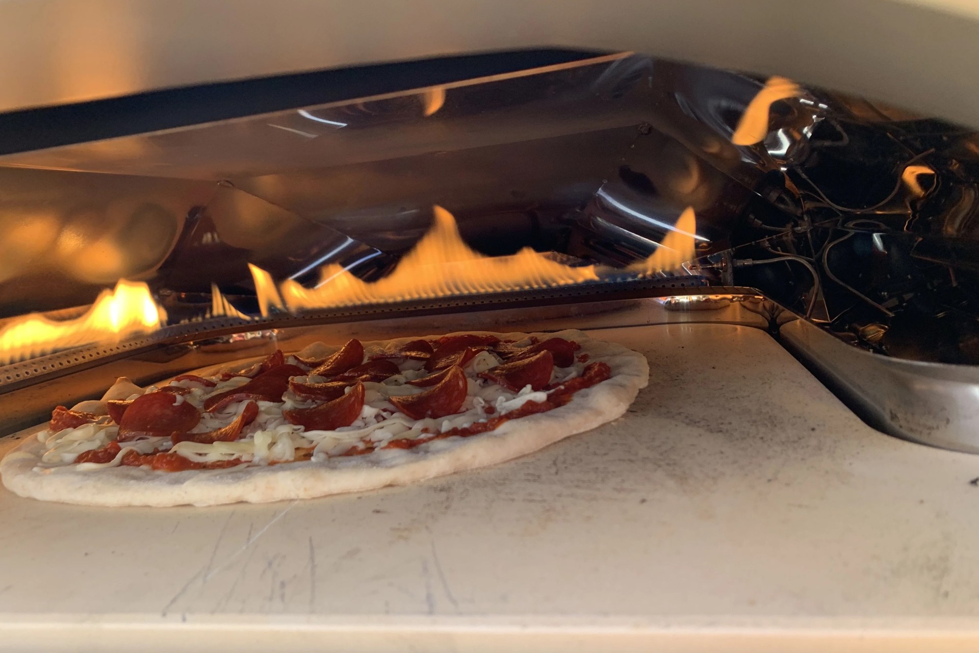 a pizza cooking in a pizza oven