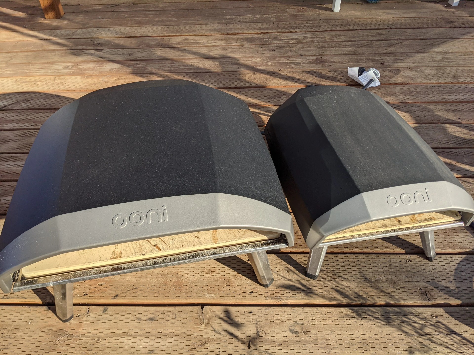 ooni koda 12 pizza oven next to an ooni koda 16 pizza oven