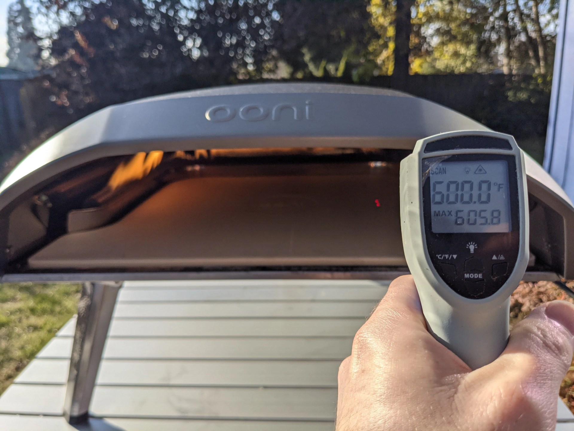 a thermometer taking the temperature of an ooni pizza oven