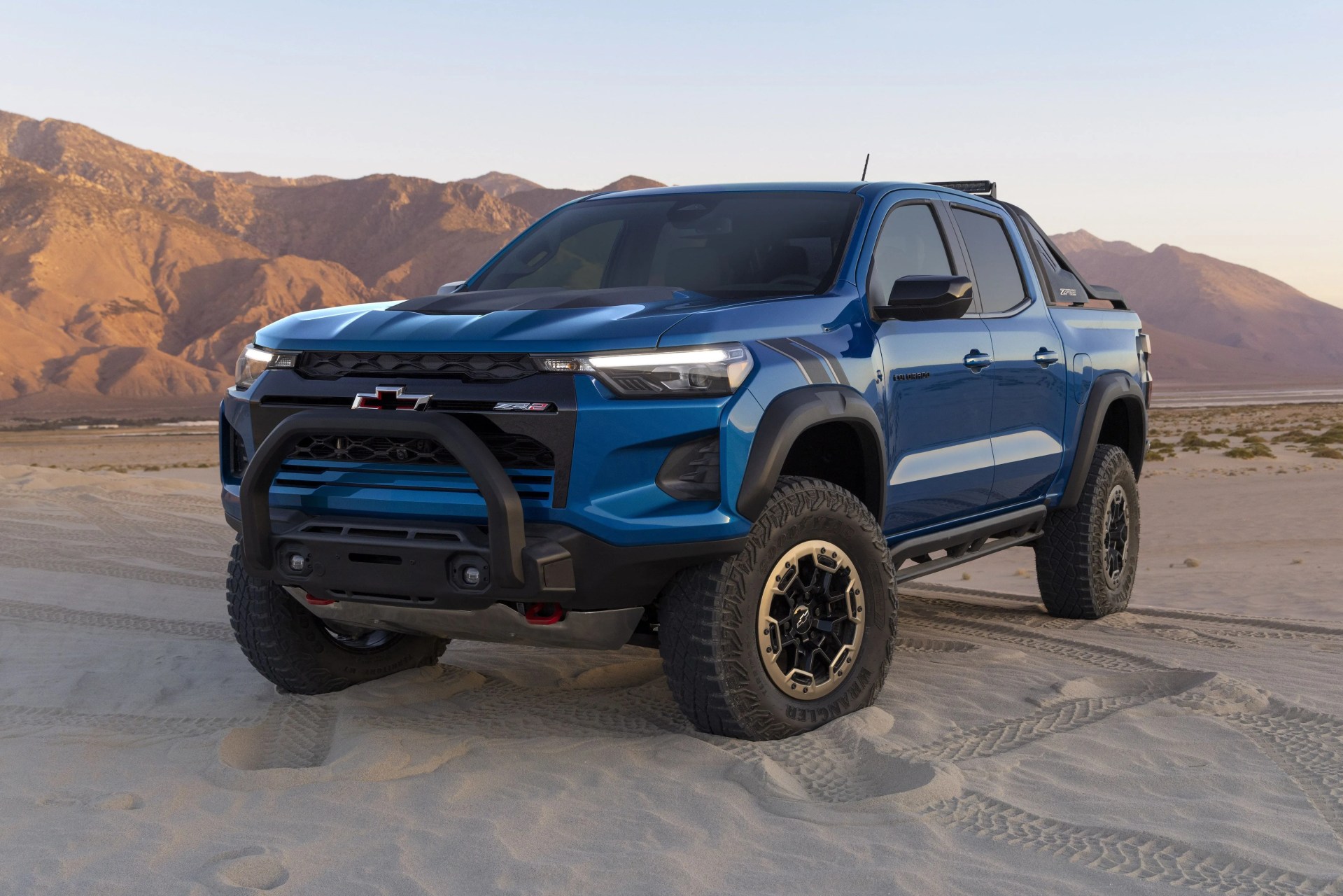 colorado zr2 desert boss parked in the desert with mountains in the background