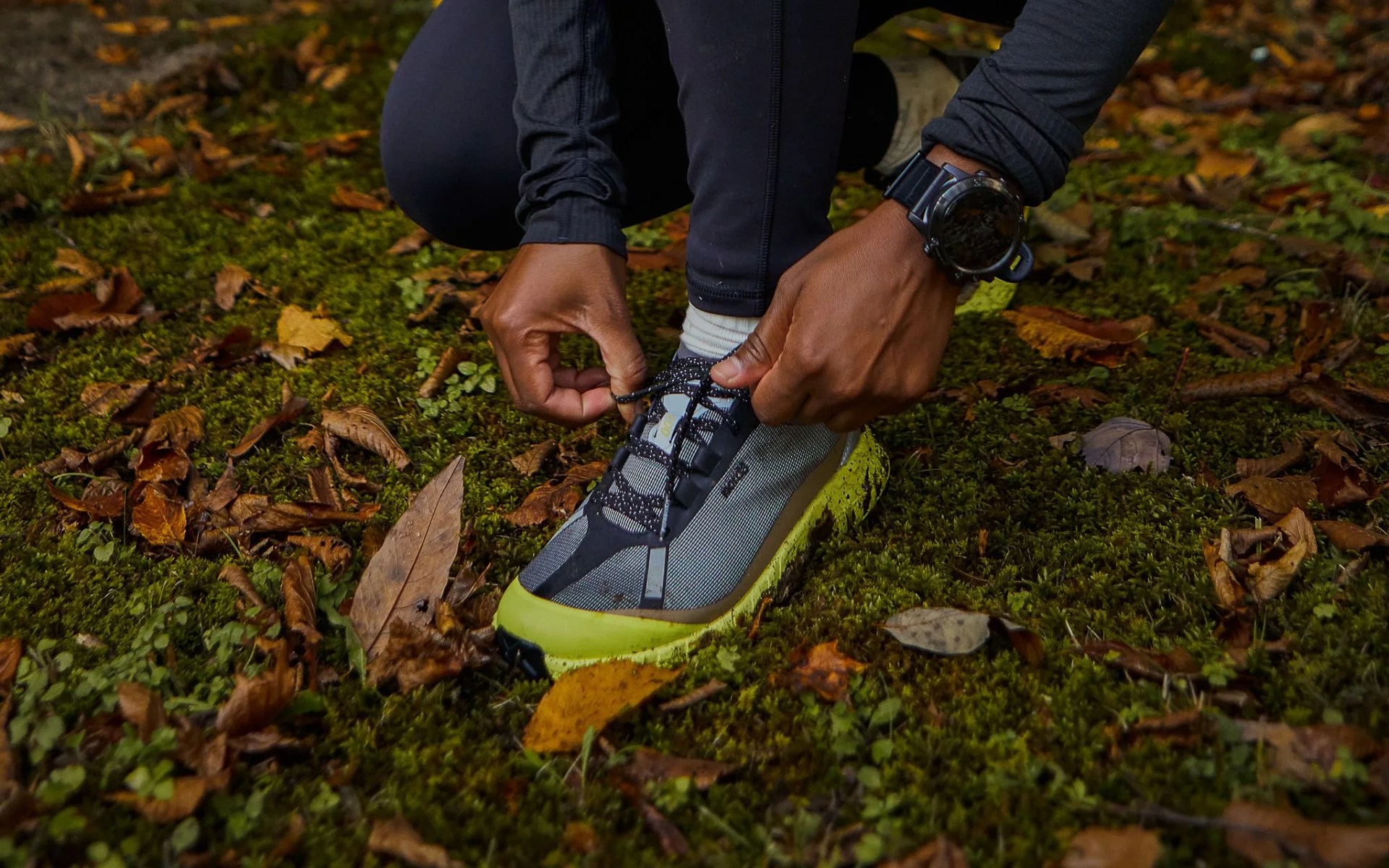 man tying his running shoe