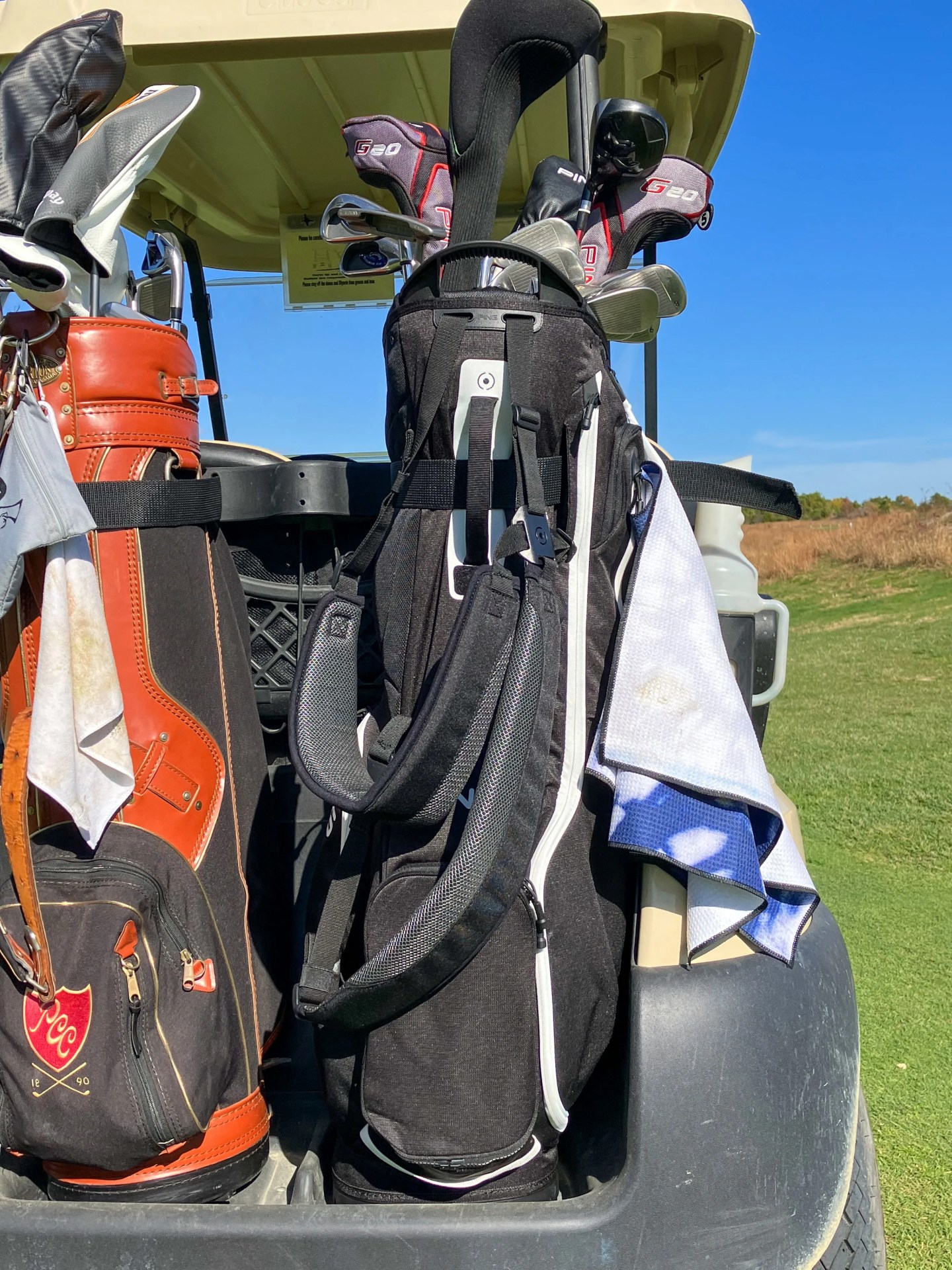 two golf bags on the back of a golf cart